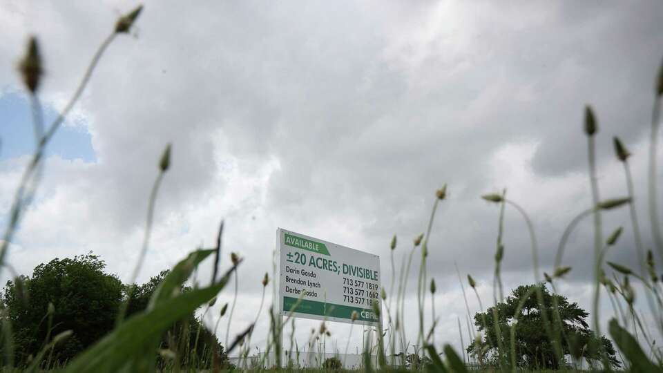 A sign advertises land for sale along South Main Street on Wednesday, April 20, 2022, in Houston. The city wants to build 240 single-family homes as part of a mixed-income development on 12.2 acres of the land at 10301 Stella Link Rd, which has a border along South Main Street.