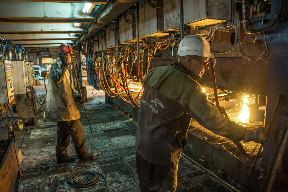 Steelworkers operate machinery during the steel-making process at the ArcelorMittal steel factory in Kryvyi Rih, Ukraine, on Thursday, May 17, 2012. ArcelorMittal just acquired 80 percent stake in a plant in Texas. 