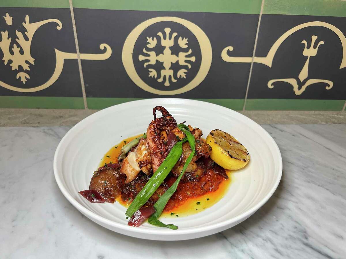 Grilled octopus incorporates fermented pepper romesco sauce, crispy potatoes and charred scallions at Allora, the new Italian restaurant the the Pearl.