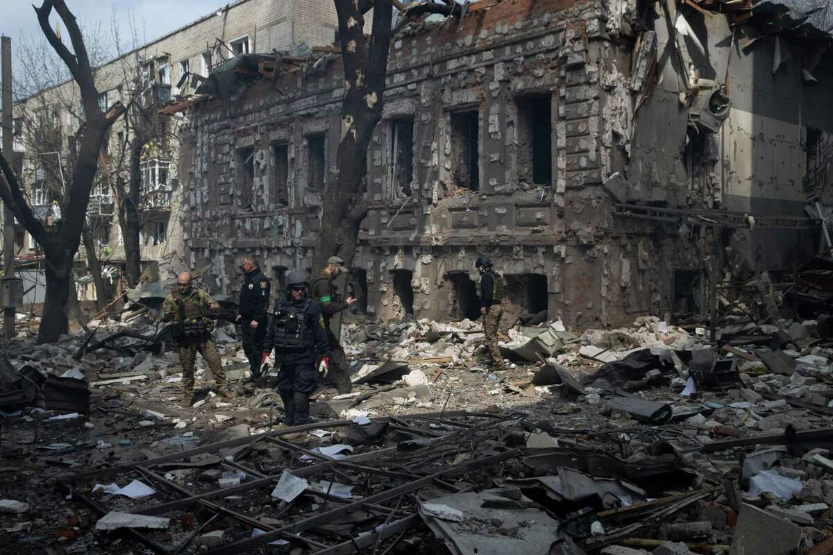 Emergency responders survey damage after what appeared to be guided missiles struck a shopping center in central Kharkiv. War causes compounding harms and must end.
