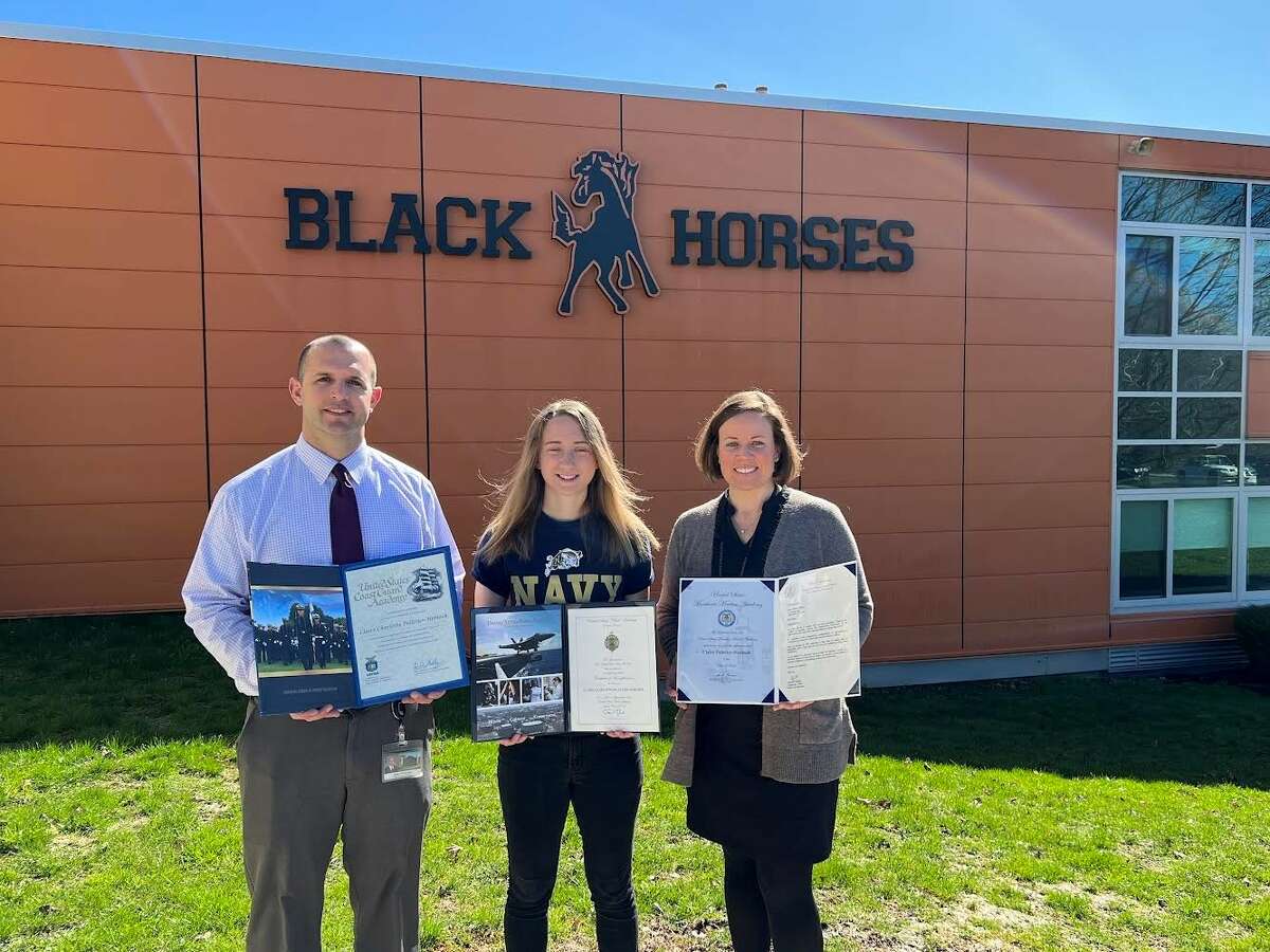 Schuylerville High School Principal James Ducharme, Claire Pelletier-Hoblock and guidance counselor Sarah Rust hold her acceptance certificates. Rust oversaw Pelletier-Hoblock's physical fitness exams.