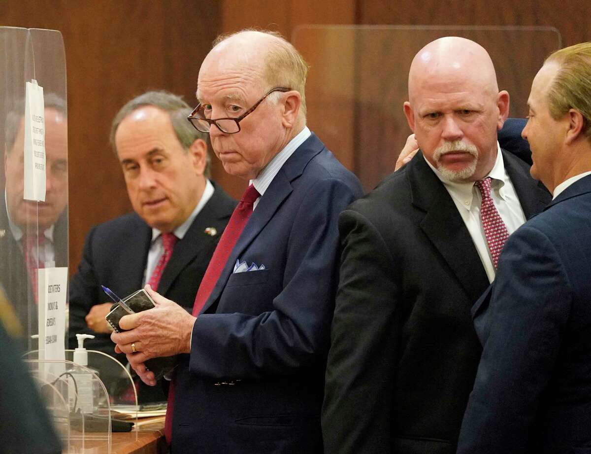 Steven Hotze, second from left, is shown during his appearance in the 482nd District Court at the Harris County Criminal Justice Center, 1201 Franklin, Thursday, April 21, 2022, in Houston along with attorneys Gary Polland, left, Terry Yates, and Jared Woodfill, right. Steven Hotze and Mark Aguirre were both indicted on charges related to their alleged involvement in an air conditioning repairman being held at gunpoint in 2020 during a bizarre search for fraudulent mail ballots.