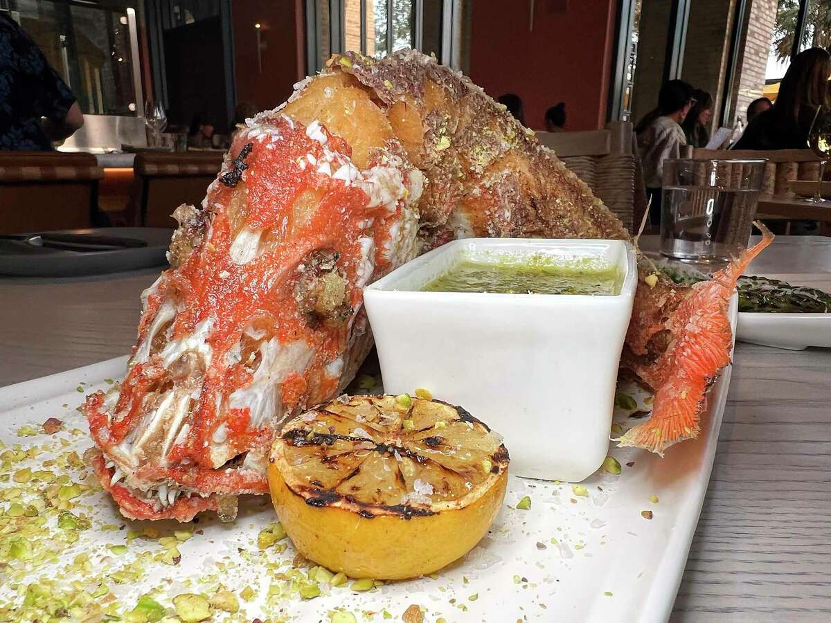 A fried whole red snapper is served with pistachio pesto butter at Allora, the new Italian restaurant The Pearl.