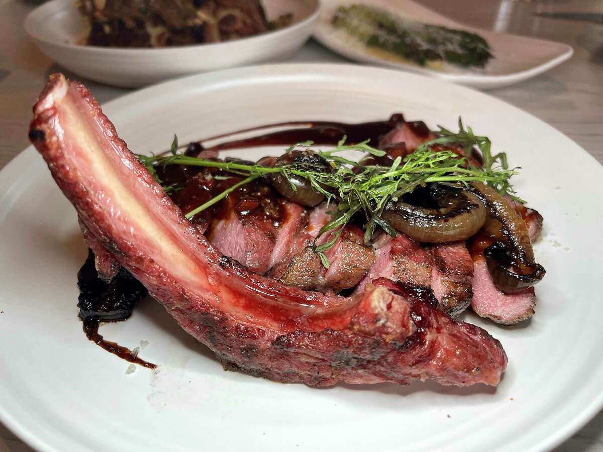 A grilled pork chop incorporates smoked ham bordelaise sauce at Allora, the new Italian restaurant the the Pearl.