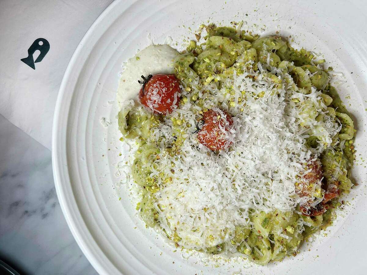 Orechiette pasta is served with pistachio pesto and blistered cherry tomatoes at Allora, the new Italian restaurant the the Pearl.