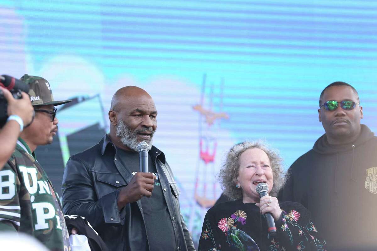 Former boxing champion Mike Tyson, left, stands onstage to greet fans during the 420 Hippie Hill event in Robin Williams Meadow at Golden Gate Park on Wednesday, April 20, 2022, in San Francisco, Calif.