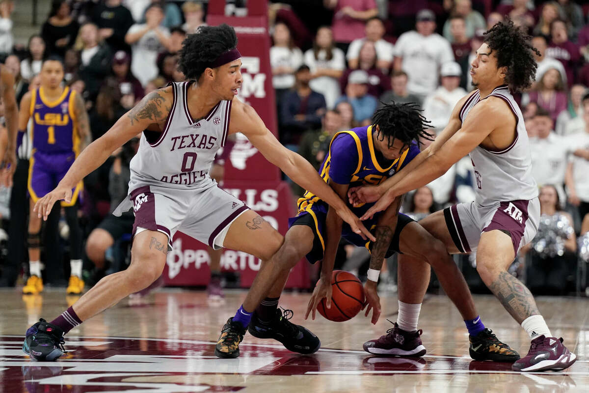 LSU guard Brandon Murray (0) is trapped by Texas A&M guard Aaron Cash (0) and guard Hassan Diarra (5) during the second half of an NCAA college basketball game Tuesday, Feb. 8, 2022, in College Station, Texas. (AP Photo/Sam Craft)