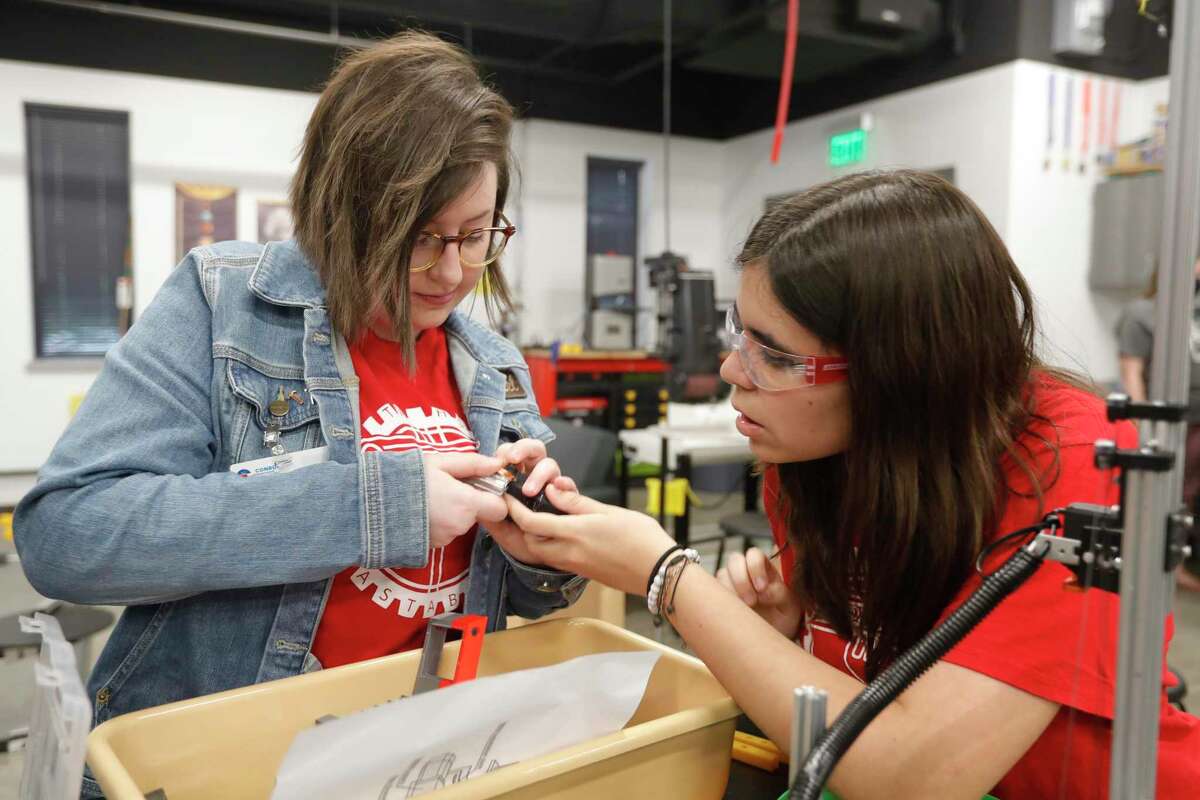 The Woodlands robotics teacher Lauren Hamel, right, helps Lucia Melero at The Woodlands High School, Wednesday, April 21, 2022, in The Woodlands. The school’s robotics team, the Rigatoni Pastabots, won first in the Tech Challenge Group II during the UIL Robotics State Championships in Houston.