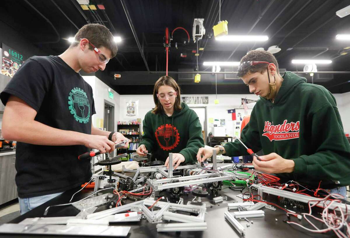 Eric Dunleavy, left, Maren Eaton and Lawrence Granda build a robot at The Woodlands High School, Wednesday, April 21, 2022, in The Woodlands. The school’s robotics team, the Rigatoni Pastabots, won first in the Tech Challenge Group II during the UIL Robotics State Championships in Houston.