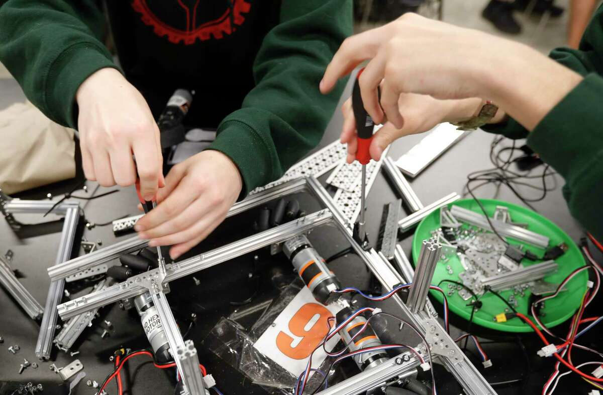 Maren Eaton and Lawrence Granda build a robot at The Woodlands High School, Wednesday, April 21, 2022, in The Woodlands. The school’s robotics team, the Rigatoni Pastabots, won first in the Tech Challenge Group II during the UIL Robotics State Championships in Houston.