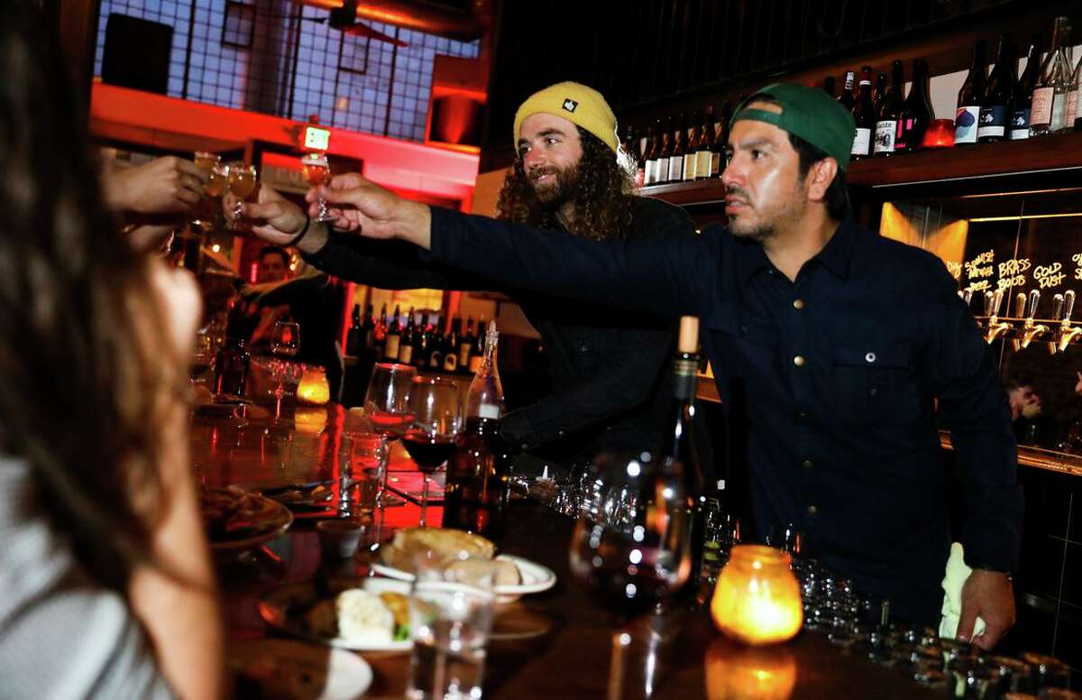 Key Klub owners Sean Halpin, left, and Lalo Luevano raise a glass.