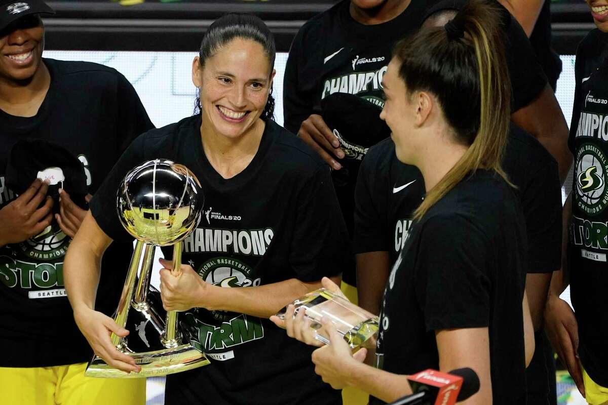 Seattle Storm guard Sue Bird, left, smiles at Breanna Stewart after the team defeated the Las Vegas Aces to win the 2020 WNBA Finals. With four former UConn players on their roster, Stewart said the Storm could be called the “Seattle Huskies.”
