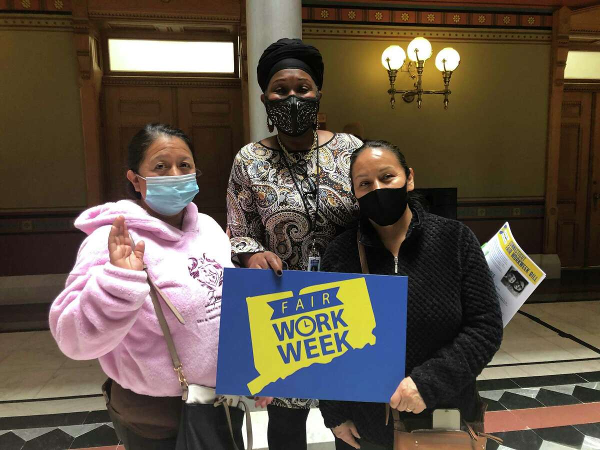 Elva Salazar, right, and her sister Betty Salazar, left, pose with state Rep. Robyn Porter, D-New Haven, at the State Capitol on Tuesday, April 12, 2022. Elva Salazar spoke during a Fair Work Week news conference with the state representative.