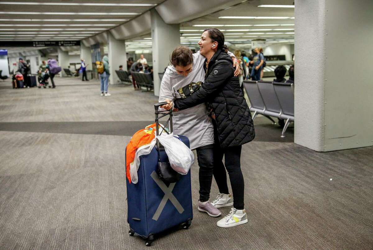 Sadaf Royeen (right) embraces her sister, Arian Royeen, at San Francisco International Airport. Sadaf and her siblings fought for eight months to have Arian rescued and brought to them. They worried about her safety and well-being given she has an intellectual disability.