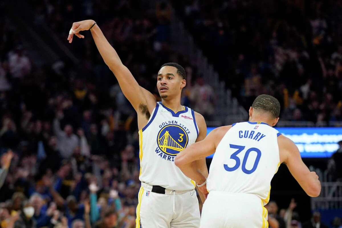 Golden State Warriors guard Jordan Poole is congratulated by and Stephen Curry after scoring during Game 2 of an NBA basketball first-round playoff series against the Denver Nuggets in San Francisco, Monday, April 18, 2022. (AP Photo/Jeff Chiu)