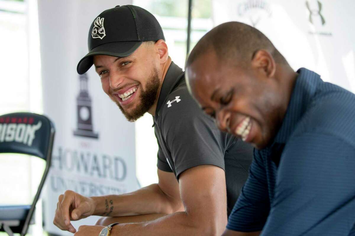 Warriors guard Stephen Curry and Howard University President Wayne Frederick laugh before a news conference in Washington on Aug. 19, 2019, when Curry announced he would be sponsoring men's and women's golf teams atat the college.