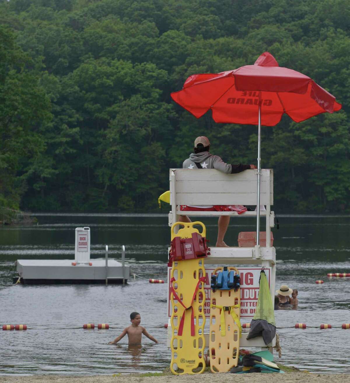 Head lifeguard Charlie Wilson of Easton, keeps an eye on swimmers at Topstone Park beach, Redding, in July 2020. DEEP is actively seeking lifeguards for the upcoming 2022 summer season at the eight Connecticut State Parks-guarded beaches.