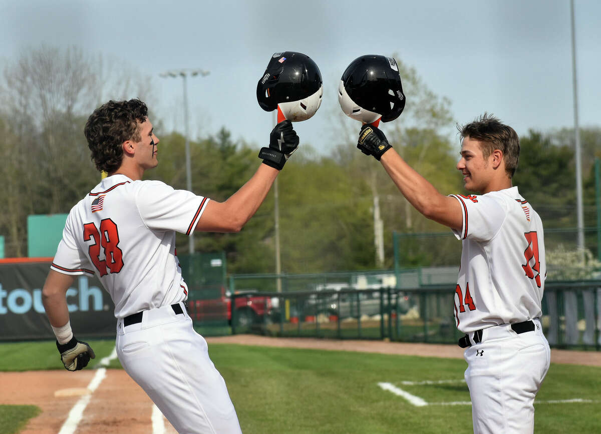 Edwardsville's Spencer Stearns, left, celebrates with Caeleb Copeland after a home run against Alton at Tom Pile Field on Thursday in Edwardsville.