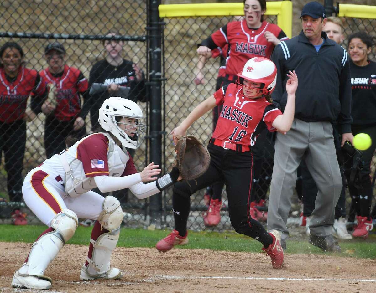 Masuk’s Angela King scores ahead of tag by St. Joseph catcher Kelsea Flanagan to give her team a 1-0 lead in the third inning on Thursday in Trumbull.