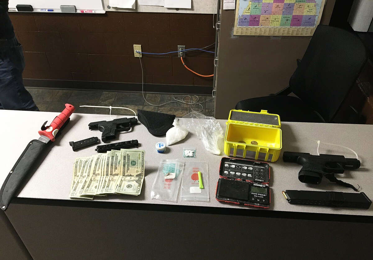 The Huron County Drug Task Force, along with Huron County Sheriff's deputies and members of the Bad Axe and Sebewaing police departments, arrested two out-of-county men and seized two handguns, cash and methamphetamine with a street value of about $6,000 during a traffic stop on M-25 south of Sebewaing on Wednesday night.