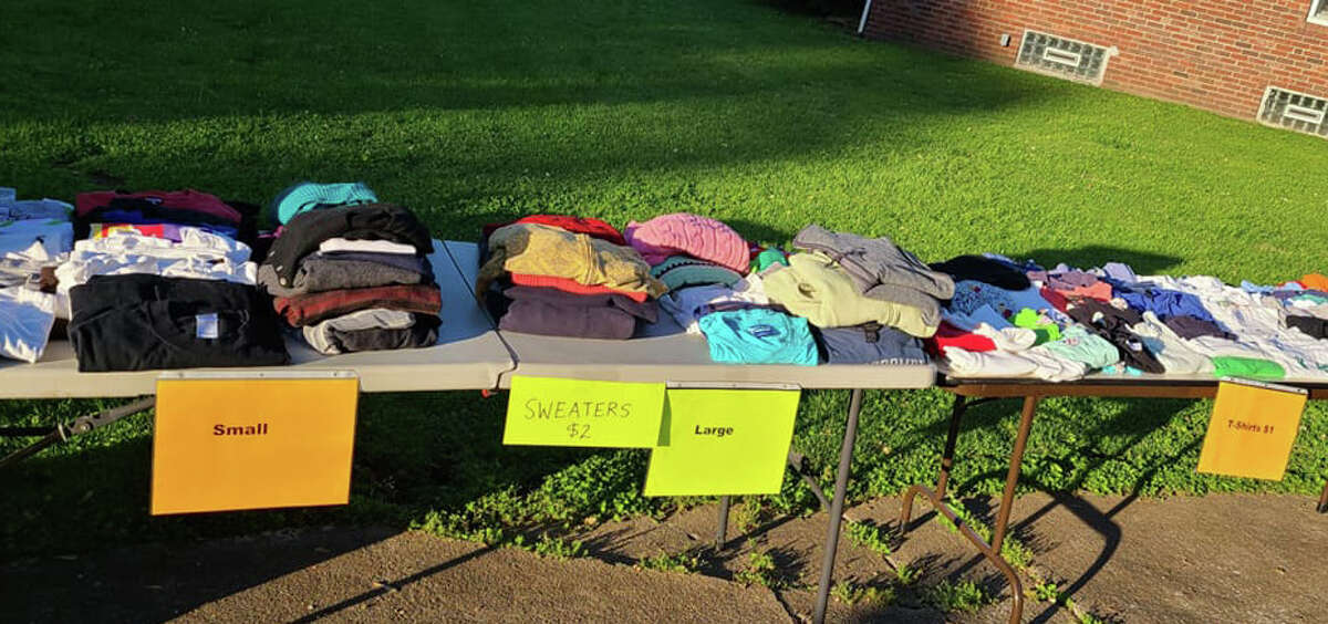 A table of clothes from a prior Collinsville yard sale. 