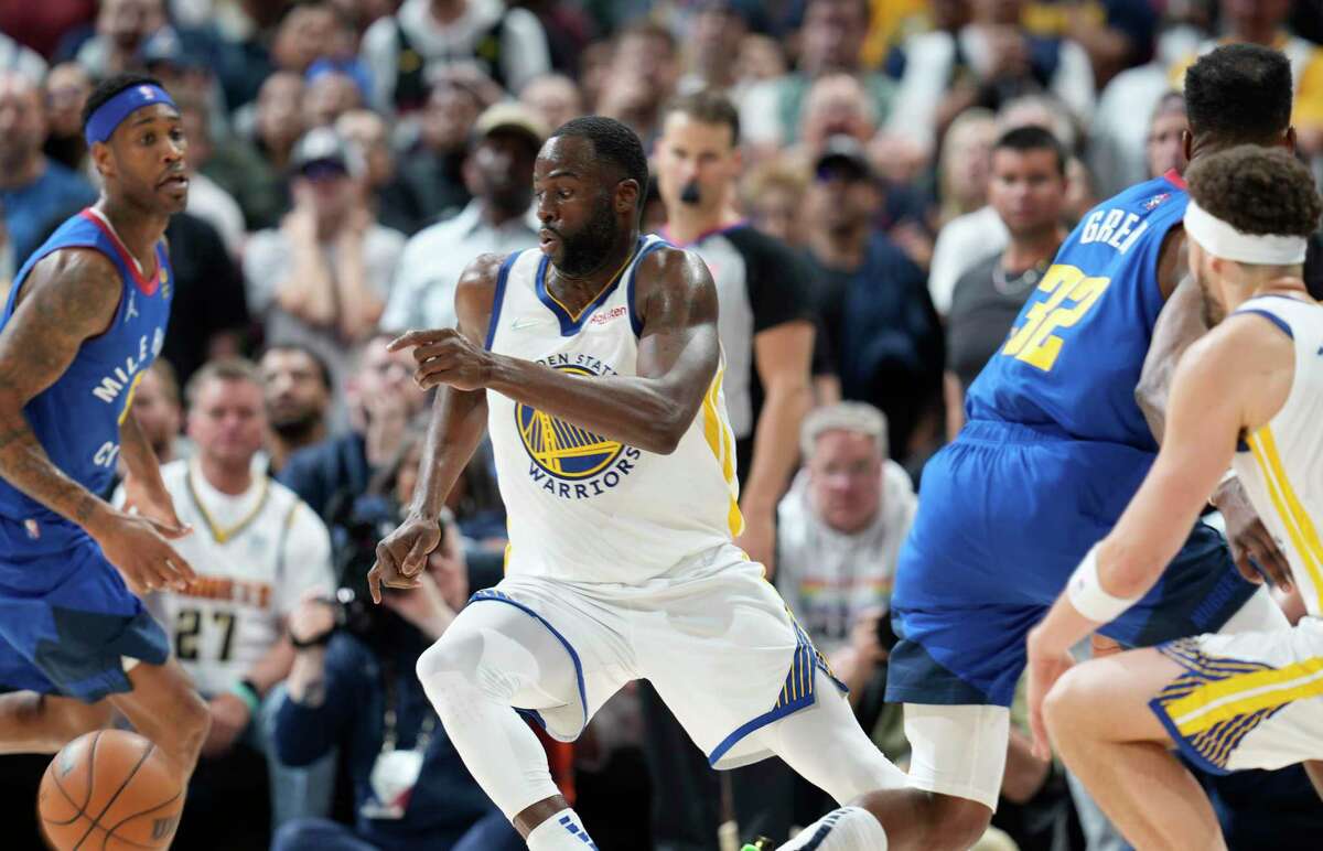 Golden State Warriors forward Draymond Green, center, pursues a loose ball between Denver Nuggets forwards Will Barton, left, and Jeff Green in the second half of Game 3 of an NBA basketball first-round Western Conference playoff series Thursday, April 21, 2022, in Denver. (AP Photo/David Zalubowski)