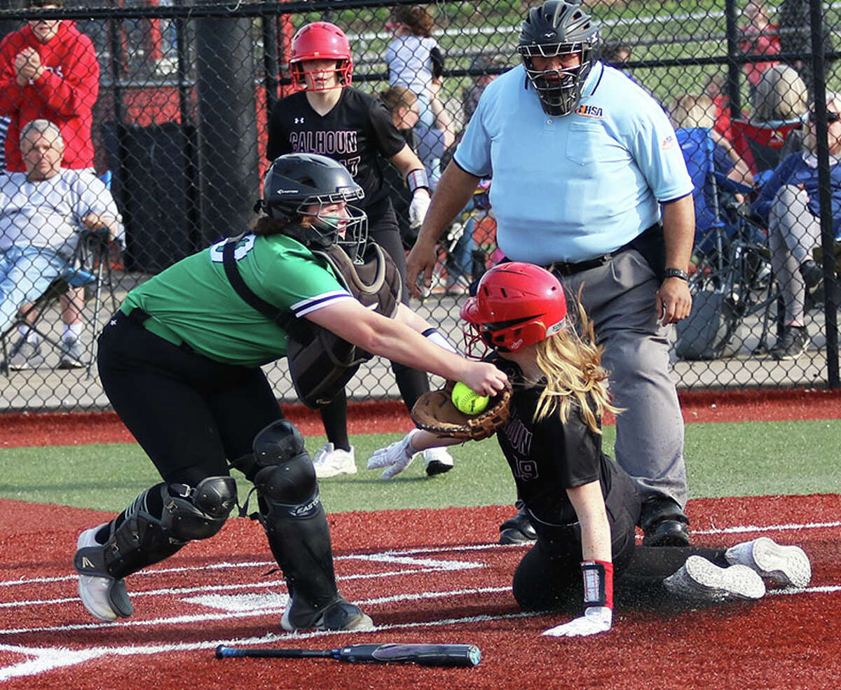 Carrollton catcher Daci Walls tags out Calhoun's Audrey Gilman, who tries to slide around the bat to reach for the plate in the fourth inning Thursday at the Future Champions Sports Complex in Jacksonville.