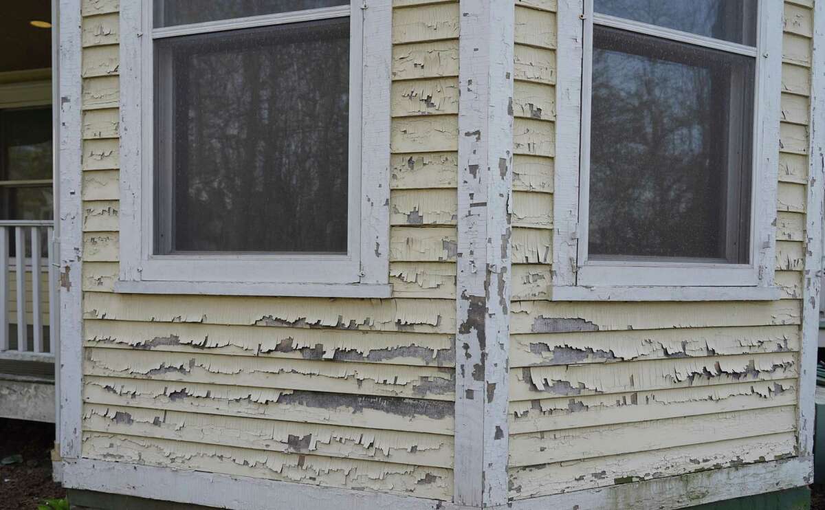 Paint is peeling and wood is rotting on Vine Cottage, the yellow Gothic revival house, circa 1859, next to Town Hall, 61 Main St., in New Canaan. The 2,335 square-foot building, which was acquired by the town in 1997, showed its wear on April 21, 2022, when this photo was taken.
