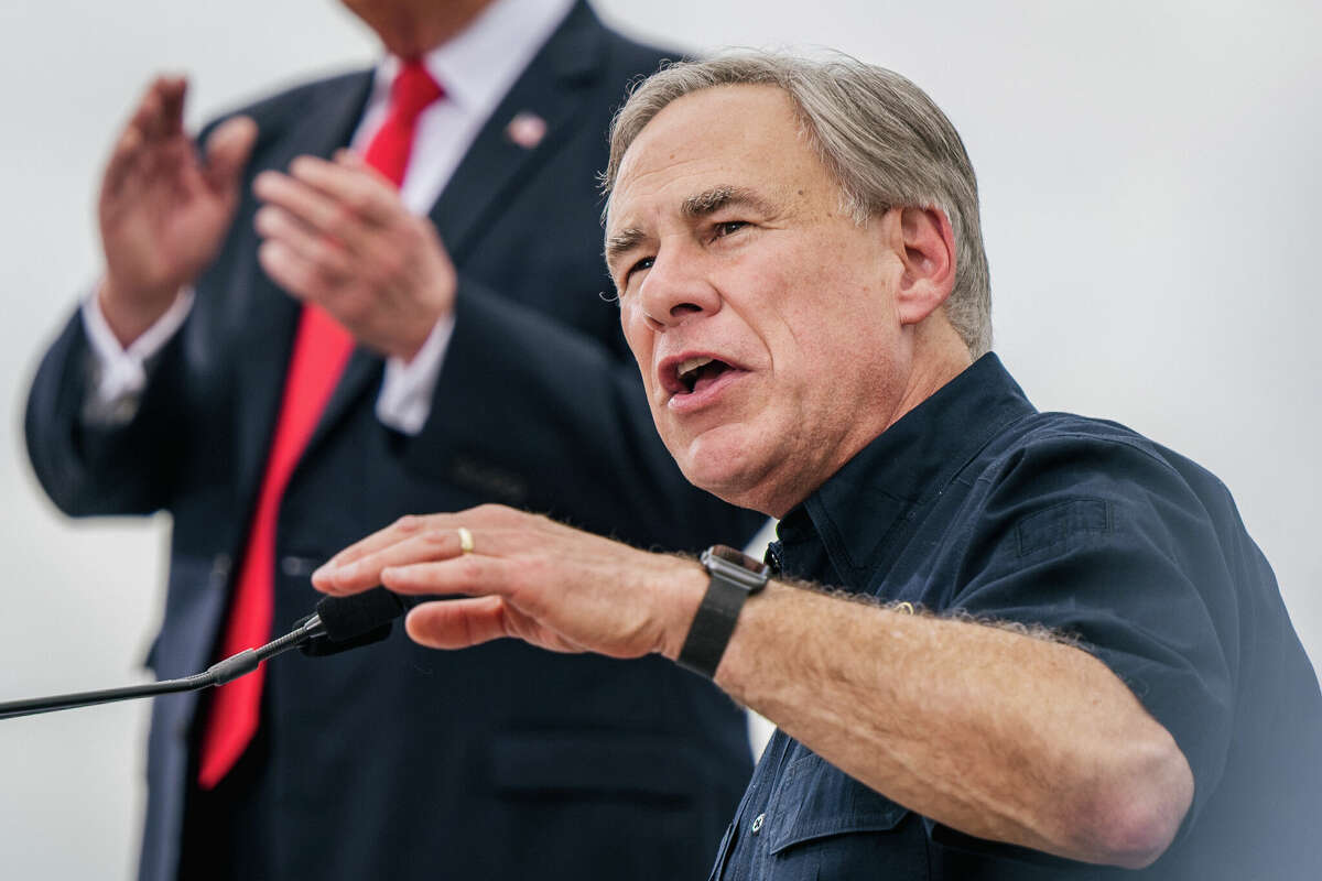 Texas Gov. Greg Abbott speaks alongside former President Donald Trump during a tour to an unfinished section of the border wall on June 30, 2021 in Pharr, Texas.
