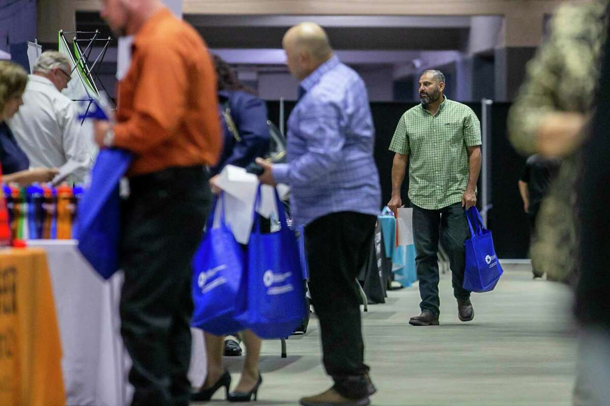People walk through the Second Chance Job Fair at Freeman Coliseum in San Antonio on Thursday. While open to all job-seekers, the fair was specifically geared toward people who have previously been incarcerated to provide opportunities and help lower the chances of recidivism.