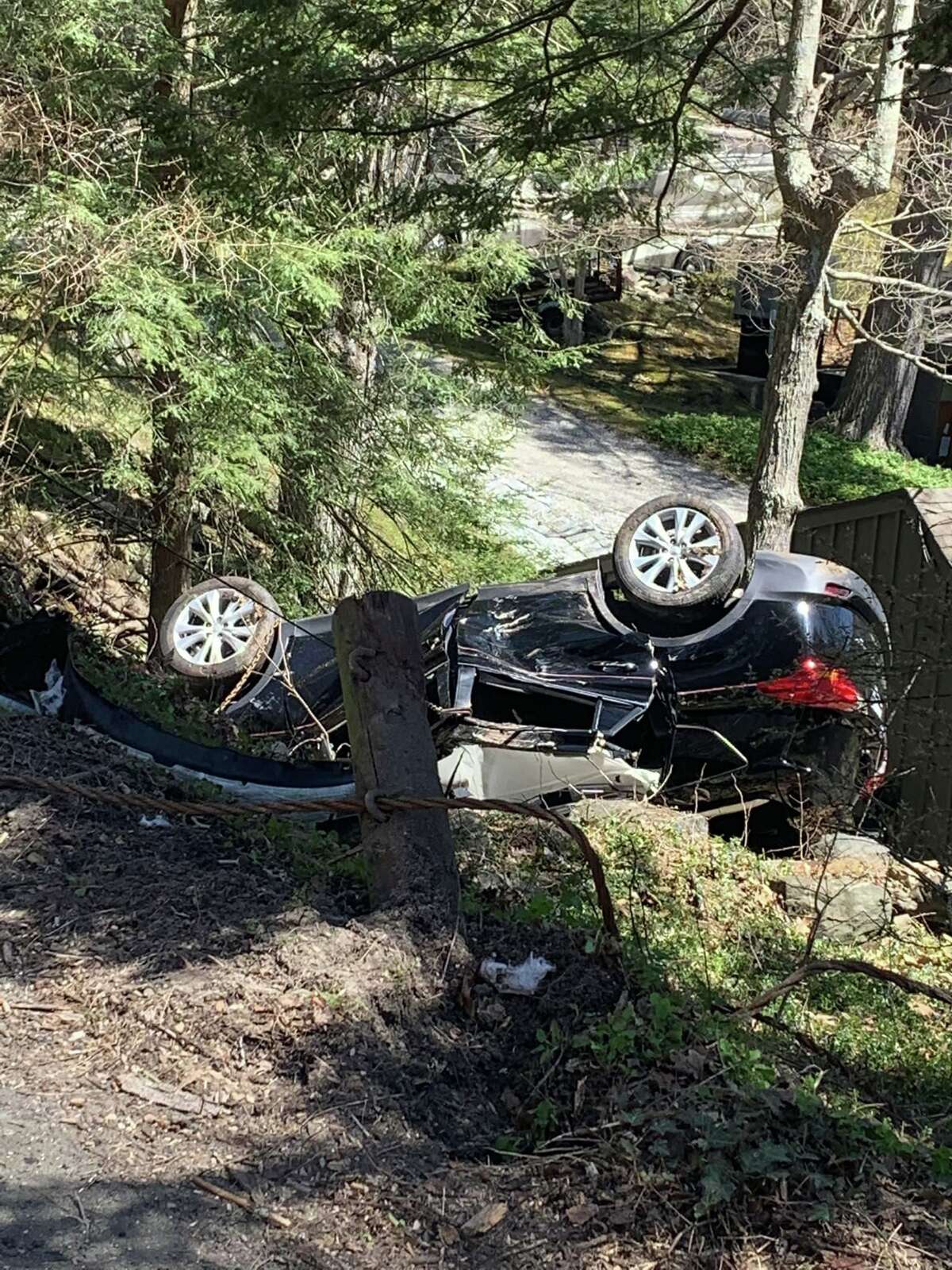 First responders found a person trapped inside a car that fell 15 feet down an embankment near the Sherman town line Friday.