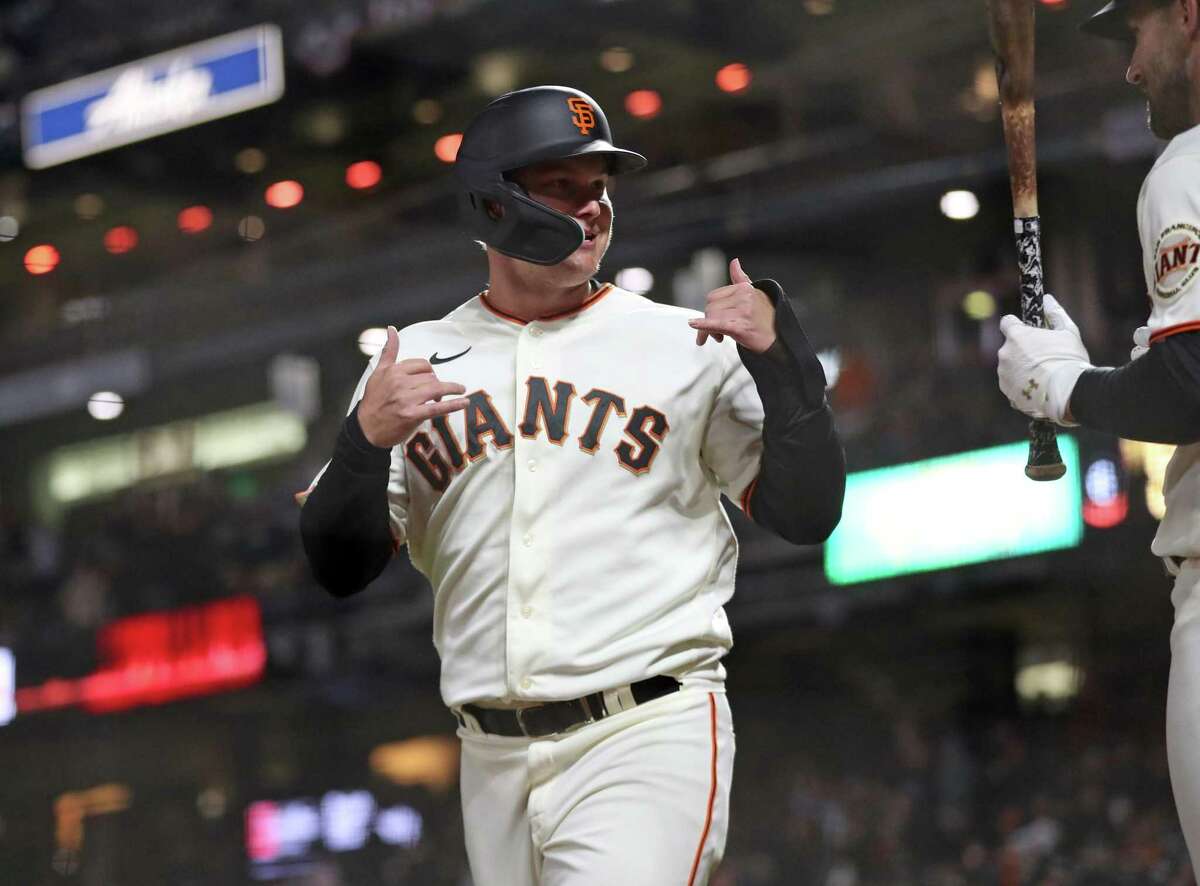 San Francisco Giants’ Joc Pederson reacts to scoring on a 6th inning wild pitch by San Diego Padres during MLB game at Oracle Park in San Francisco, Calif, on Monday, April 11, 2022.
