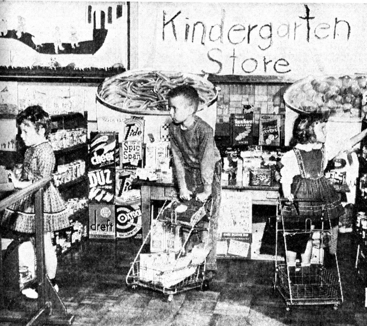 Through the efforts of Kay Claypool who wrote to various companies for the products, the Washington School kindergarten class has a model grocery store with real merchandise. The students gain experience and knowledge in choosing products, stocking shelves, making change and at the same time having a good time playing store. (From left) Susie Cooper, David Johnson and Shanon Howe are shown in this photo that published in the News Advocate on April 25, 1962.