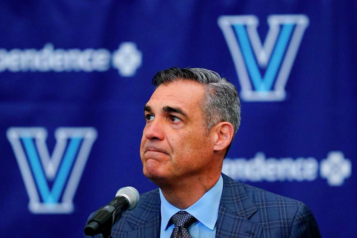 Jay Wright grimaces while speaking at a news conference about his resignation as men’s basketball coach at Villanova on Friday.
