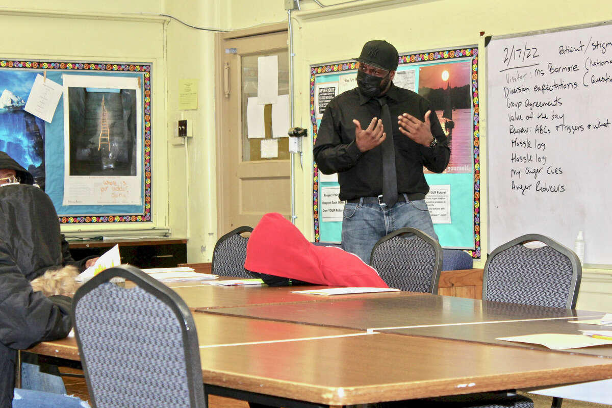 Nathaniel Wylie, who is trained in therapeutic crisis intervention, works with students participating in an aggression replacement group therapy session on how to recognize and control anger and other behaviors that landed them on long-term suspension.