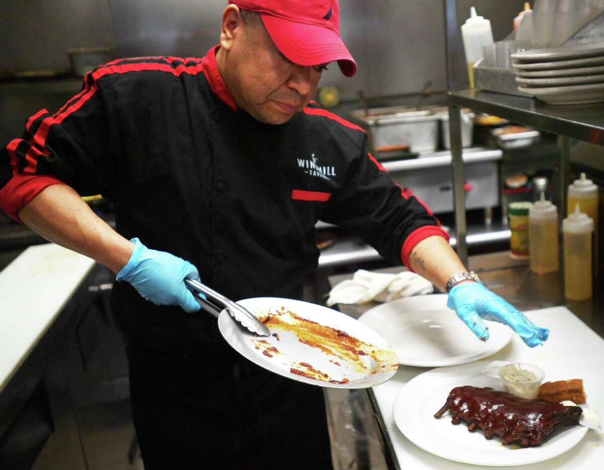 Diego Jimenez plates a rack of Johnny's Ribs, one of four entees available on the three course prix fixe menu, for Stratford Restaurant Week at the Windmill Tavern in Stratford, Conn., on Thursday, April 21, 2022.