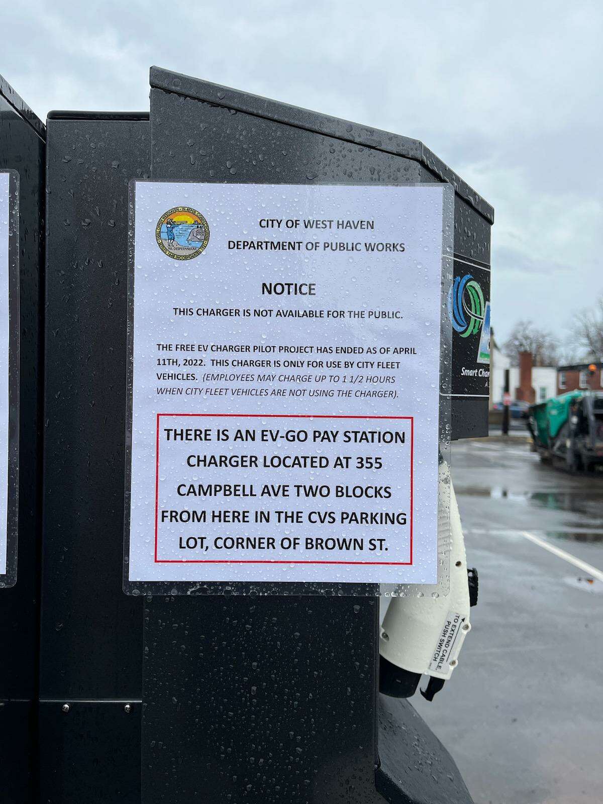A sign affixed to an electric vehicle charging station in the parking lot of West Haven City Hall on April 20, 2022.