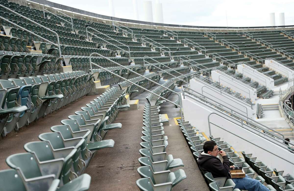 A man has most of the upper deck to himself as Oakland Athletics play Baltimore Orioles in front of a couple thousand fans during MLB game at Oakland Coliseum in Oakland, Calif, on Wednesday, April 20, 2022.