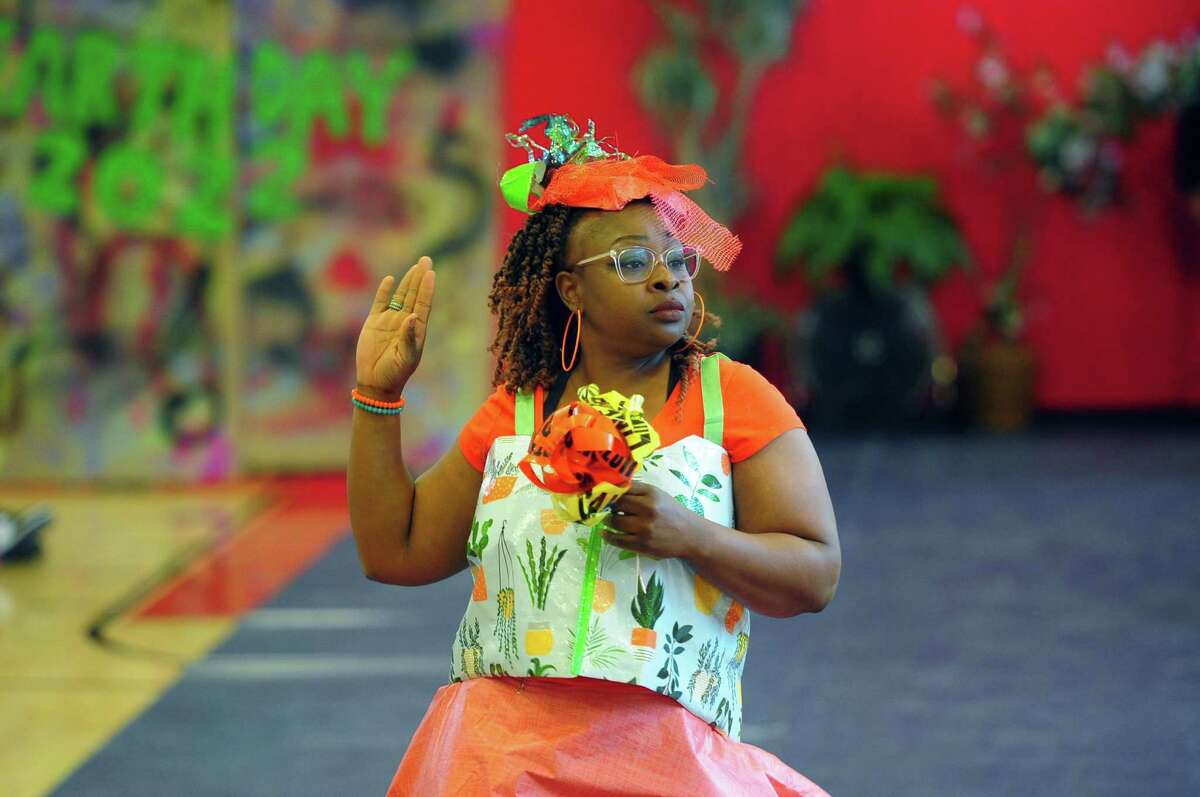 As part of J.M. Wright Technical High School's Earth Day Celebration, teacher Latrina Annosier models as a bridesmaid during its "trashy" fashion show in the gymnasium in Stamford, Conn., on Friday.