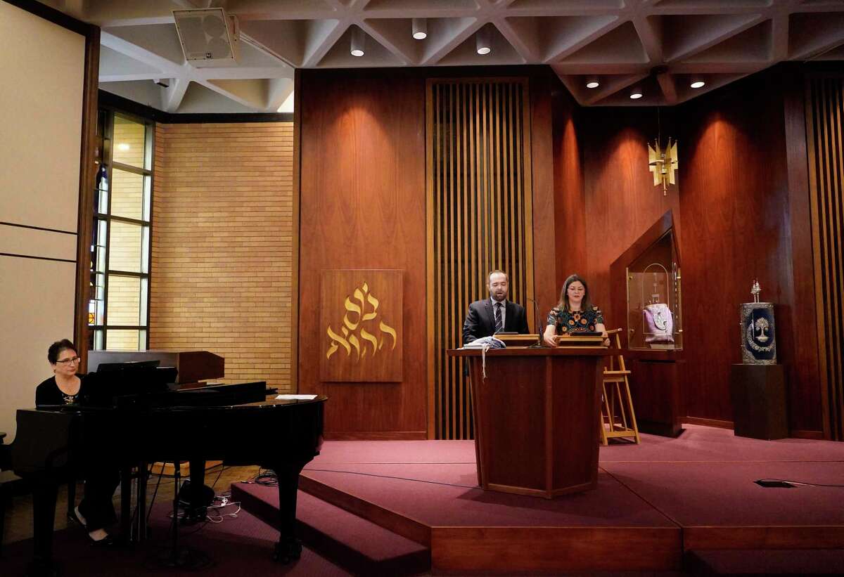 Yanina Didyk, pianist, left, cantor Josh Breitzer and cantor Rollin Simmons, right, rehearse before the Passover service at Congregation Emanu El, 1500 Sunset Blvd., Friday, April 22, 2022, in Houston.
