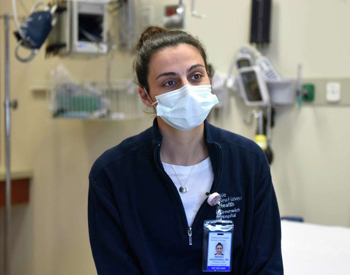 Emergency department nurse manager Amanda Jagodzinski, RN, chats at Greenwich Hospital in Greenwich, Conn. Wednesday, April 20, 2022. Jagodzinski found out she was pregant in January 2020 at the beginning of COVID and continued working in the hospital's emergency department throughout her term until she gave birth to a healthy baby girl, Gianna, on Aug. 28, 2020.