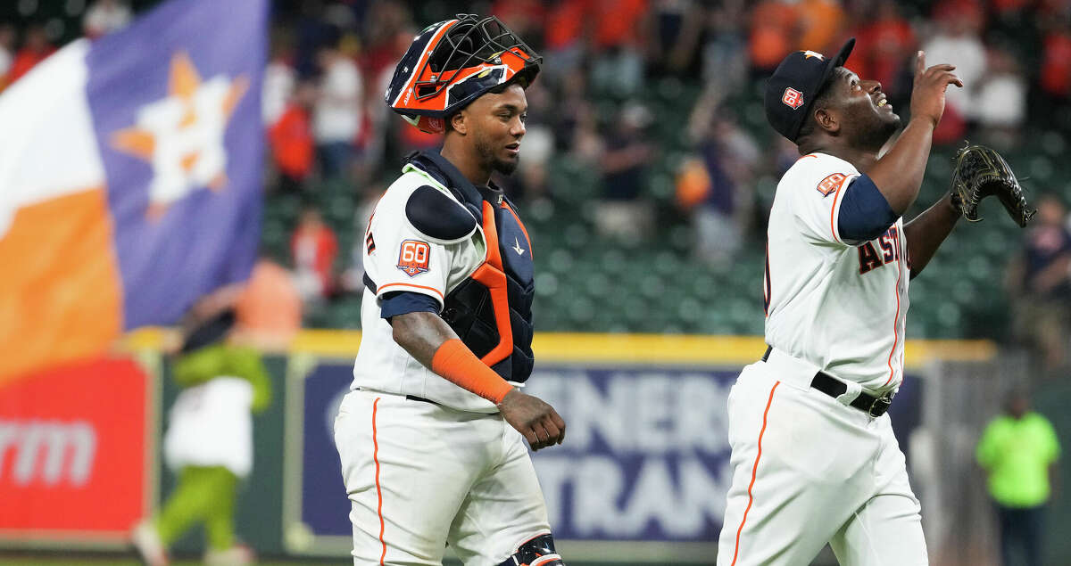 Houston Astros relief pitcher Hector Neris (50) and catcher Martin Maldonado (15) walk off the field after the Astros took an 8-3 win over the Los Angeles Angels in a major league baseball game Monday, April 18, 2022, at Minute Maid Park in Houston.