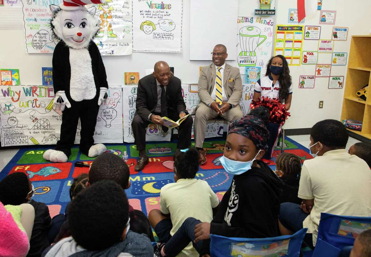 Mayor Sylvester Turner, left, and HISD Superintendent Millard House II celebrate Houston Reads Day by reading books to second grade students at Bruce Elementary School Wednesday, March 2, 2022, in Houston. Turner read “Fox in Socks,” and House read one of his favorite books, “Green Eggs and Ham.”