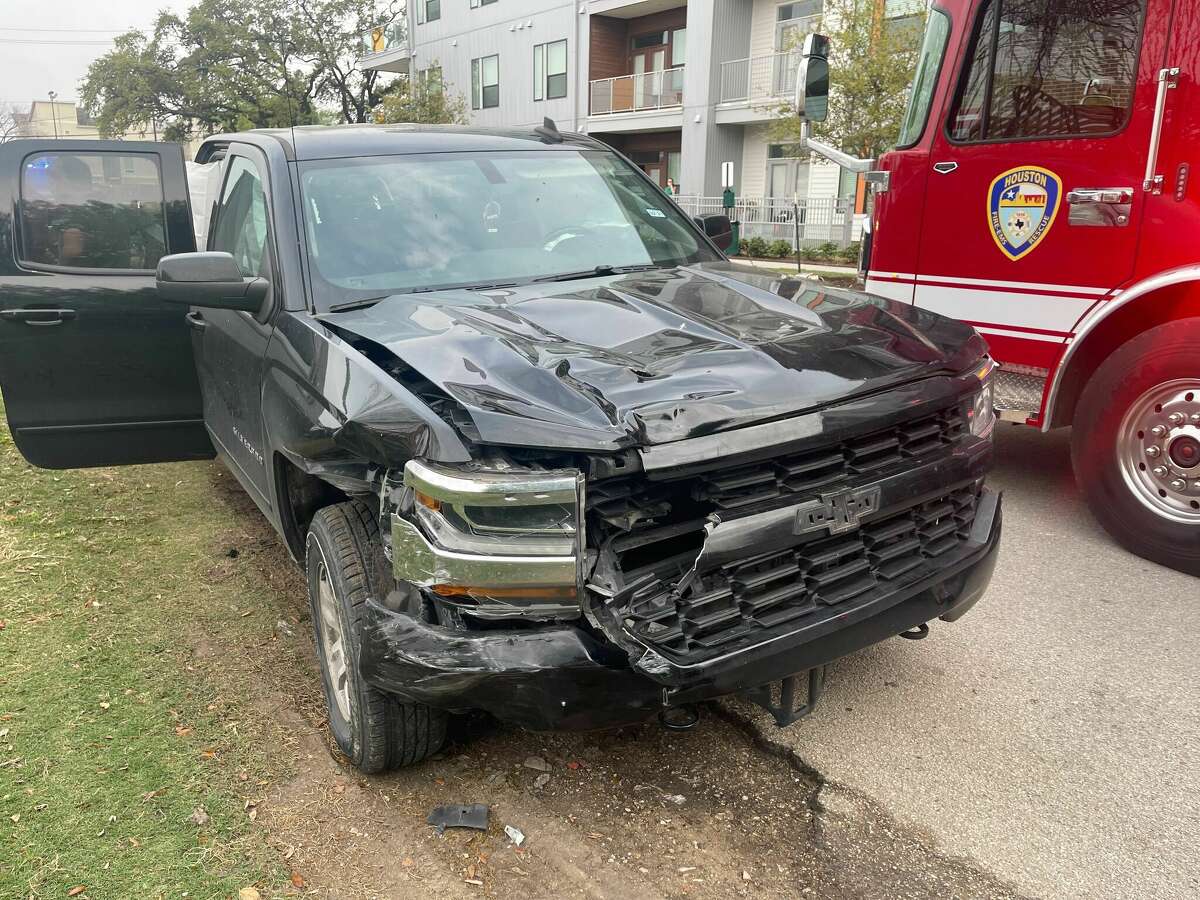 This photo shows damage to a driver's pickup after hitting a parked Tesla Model 3 minutes after Houston police released him from the scene of a deadly collision with a pedestrian on Tuesday, April 5, 2022.