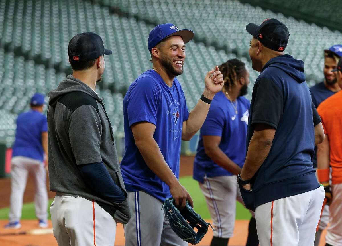 Toronto Blue Jays center fielder George Springer (4), center, catches up with former his former teammates during batting practice at Minute Maid Park on Friday, April 22, 2022, in Houston.