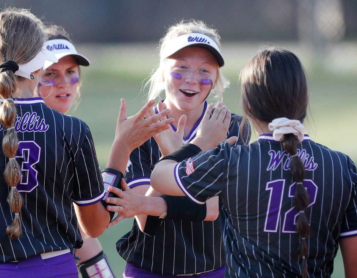 Willis players celebrate after defeating Conroe 5-2 to clinch one of the four District 13-6A high school softball playoff spots, Friday, April 22, 2022, in Conroe.