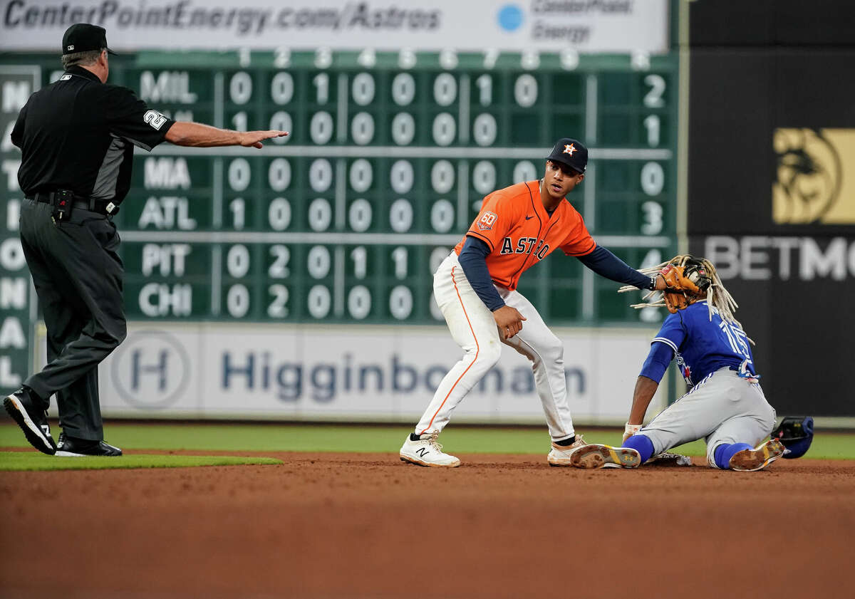 Toronto Blue Jays right fielder Raimel Tapia (15) steals second base against the Houston Astros during the eighth inning of an MLB game at Minute Maid Park on Friday, April 22, 2022, in Houston.