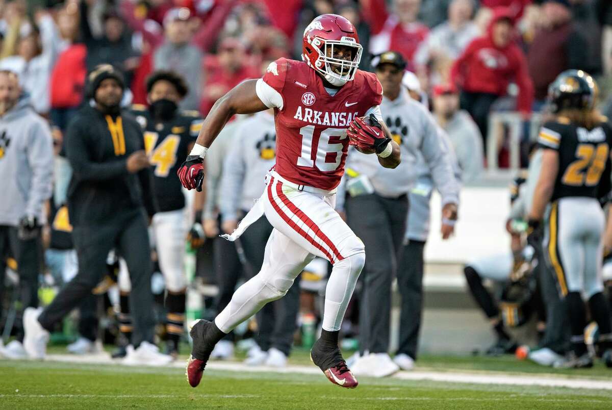 Treylon Burks #16 of the Arkansas Razorbacks catches a pass for a touchdown during a game against the Missouri Tigers at Donald W. Reynolds Razorback Stadium on November 26, 2021 in Fayetteville, Arkansas. The Razorbacks defeated the Tigers 34-17. (Photo by Wesley Hitt/Getty Images)
