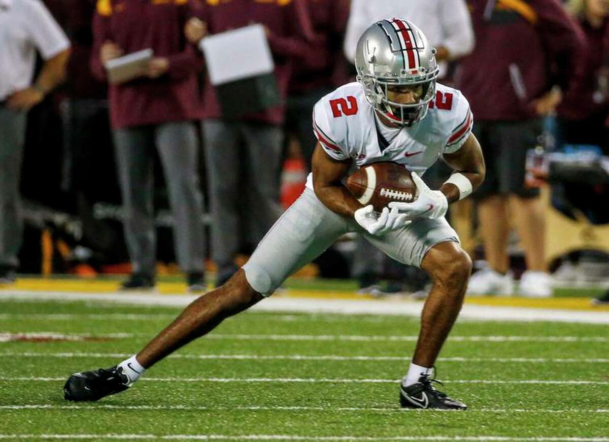 Ohio State wide receiver Chris Olave (2) catches a pass against Minnesota in the second quarter of an NCAA college football game Thursday, Sept. 2, 2021, in Minneapolis. (AP Photo/Bruce Kluckhohn)