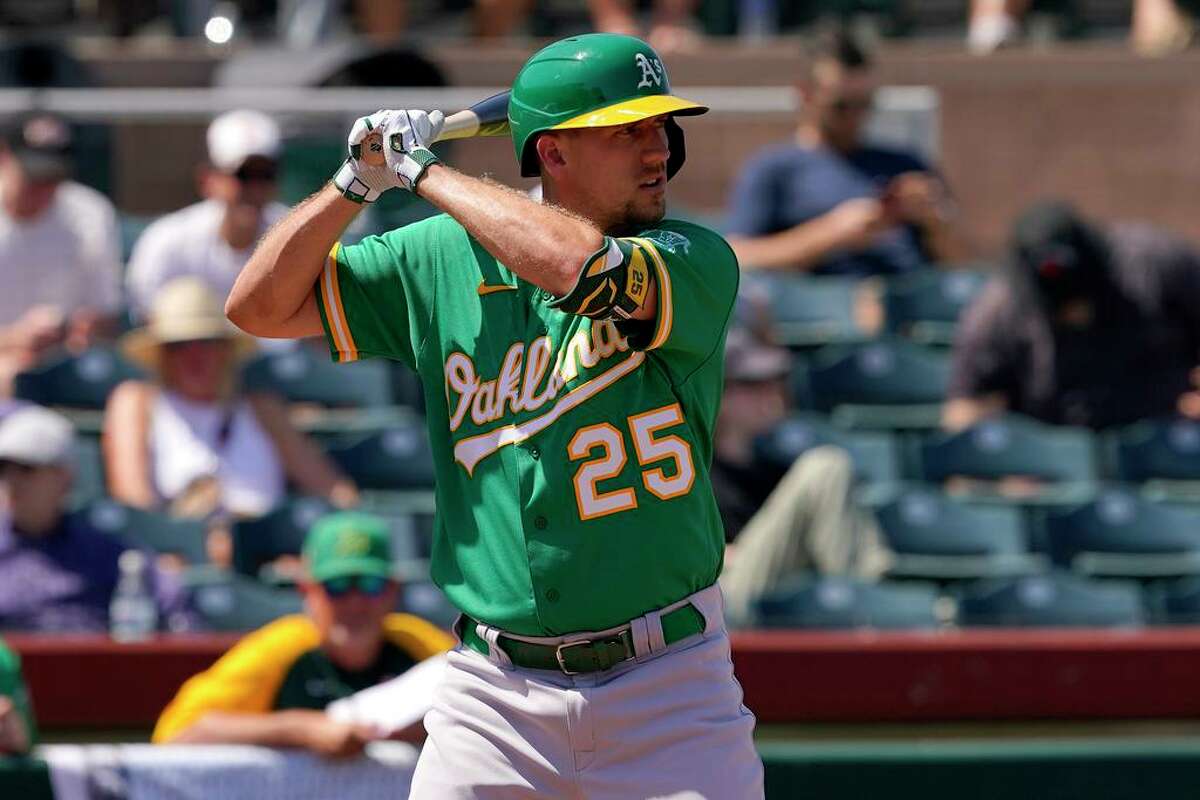 Oakland Athletics right fielder Stephen Piscotty (25) hits against the San Francisco Giants during the second inning of a spring training baseball game, Tuesday, April 5, 2022, in Scottsdale, Ariz. (AP Photo/Matt York)